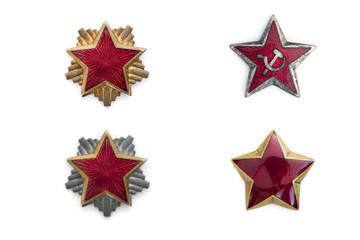 Obraz premium Old red stars from military caps isolated on the white background