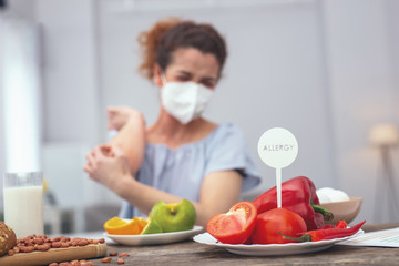 Protection from allergy. Young girl protecting her breathing passages with a respiratory mask so...