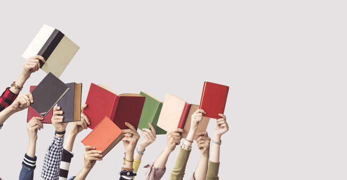 The hands of people hold books