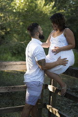 Fototapeta premium Couple expecting baby are posing for pregnancy photography