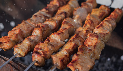 Grilling shashlik on barbecue grill