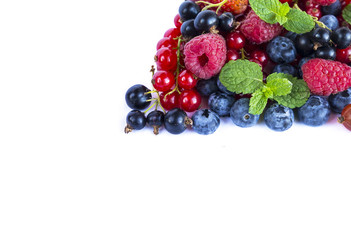 Fruits and berries on white background. Ripe red currants, raspberries, blueberries,  strawberries. Sweet and juicy fruits with copy space for text.