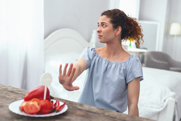 Unfortunate allergy. Young beautiful girl looking upset about being unable to include fresh...