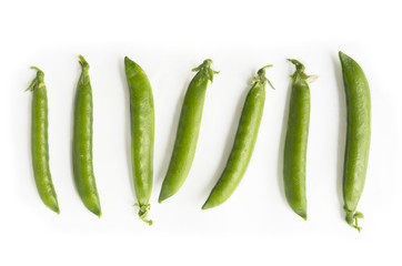 Green peas isolated on a white background. Vegetables with copy space for text. Fresh green peas on a white background. Studio photo. 