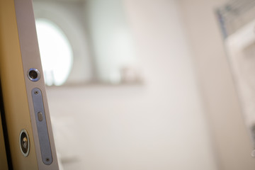 White bathroom. Open door and blur interior