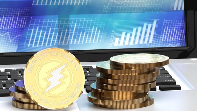 A bunch golden electroneum coins, bitcoin alternatives, on a laptop, close up