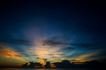 The sky and the sun rise over the sea in southern Thailand.