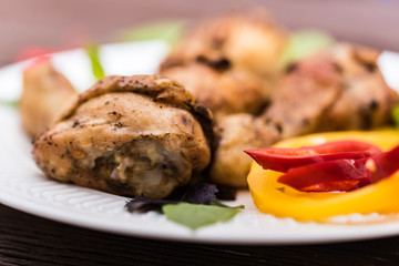 Roasted chicken quarter legs on rustic background
