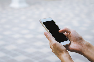 man holding smartphone using touching on black screen in hand.