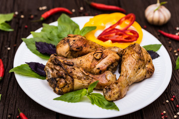 Roasted chicken quarter legs on rustic background
