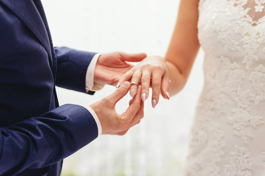 Wedding ring. Bride's hands. Groom's hands