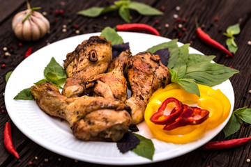 Roasted chicken quarter legs on rustic background