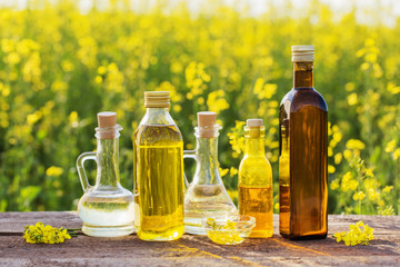 rapeseed oil on wooden table in field