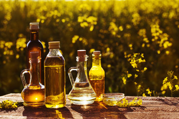 rapeseed oil on wooden table in field