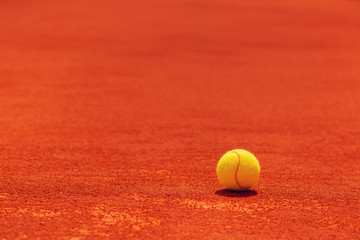 Tennis ball on clay court