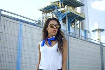 Stylish young woman in a factory