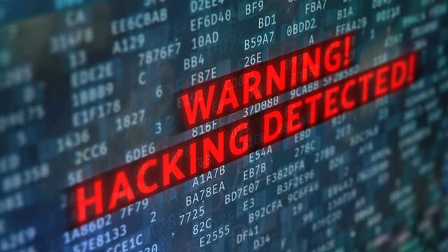 Alert message, hacking detected on screen, system under attack, data theft. Screen text with warning message