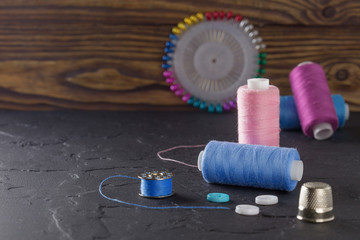 sewing thread on bobbins of blue and pink color