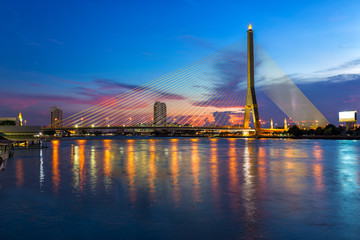 Rama 8 bridge is a cable stayed bridge crossing the Chao Phraya River and transportation at sunset, the famous landmark in Bangkok, Thailand.