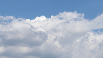 Naklejka na ściany i meble Sky of blue color with big white clouds.