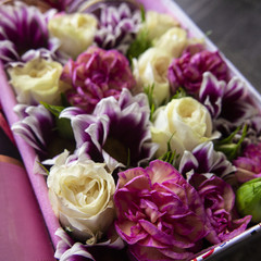 bright composition of macaroni, flowers and a bottle of wine