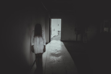 Close up woman wear white shirt in the dark room,Scary movie concept,Horror background,Thailand...