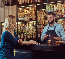 Stylish brutal barman serves an attractive couple who spend an evening on a date.