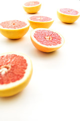 Naklejka na ściany i meble Sliced grapefruits on white background.