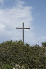 metal cross on a hill in sardinia 