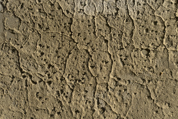 background, texture - brown clay wall with bumps and cracks