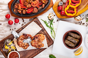 Assorted turkish food on white background. Chicken, vegetables, tomato, spices. Dishes and appetizers of turkish cuisine. Top view food. Place for text