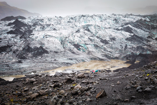 Glacier tongue Svinafellsjokull in Vatnajokull National Park, dyed black due to the ashes of the famous volcano Eyjafjallajokull, Iceland