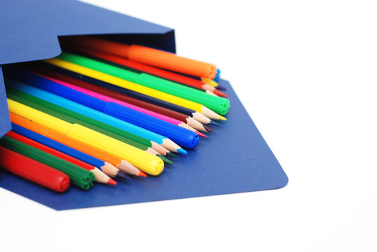 Colored Pencils in blue envelope Isolated on White Background Copy Space School Suplies