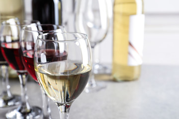 Elegant glasses with delicious wine on table