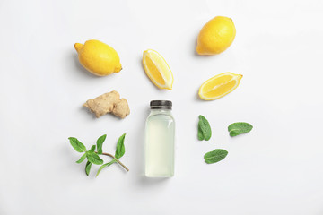 Flat lay composition with delicious natural lemonade on white background
