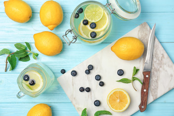 Flat lay composition with delicious natural lemonade on color background