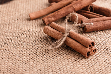 Cinnamon essential oil on a wooden background