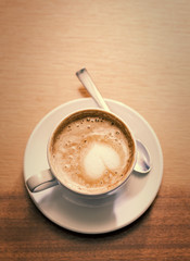 Coffee cup with milk on the table