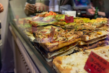Local bakery selling delicious pizzas and focaccia bread.