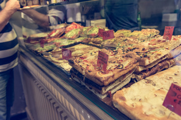 Local bakery selling delicious pizzas and focaccia bread.