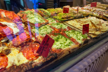 Local bakery selling delicious pizzas and focaccia bread.