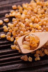 frankincense essential oil on a wooden background