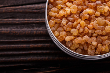 frankincense essential oil on a wooden background