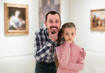 Fototapeta premium Father and small daughter exploring pictorial art