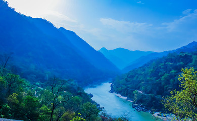 Fototapeta na wymiar morning top view of Holy Ganges river that flows through Rishikesh passage of mountains looks divine 