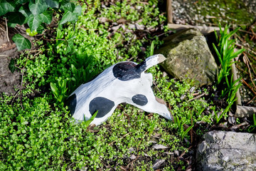 Garden decoration. Dog figure on the lawn in a garden