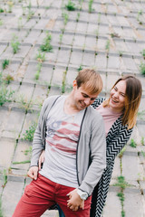 Two lovers walk around the park, kiss and hug, a love story.