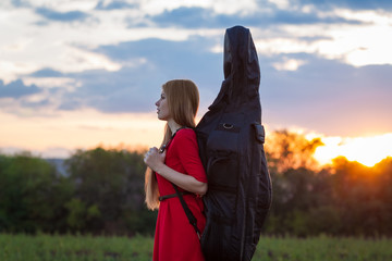 Woman violoncellist with cello at nature © Andrey Milkin