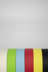 Bright colorful tape rolls in a pattern on an isolated white background with room for text and other objects! 