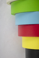 Bright colorful tape rolls in a pattern on an isolated white background with room for text and other objects! 